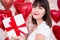Valentine`s day concept - close up portrait of happy dreaming woman with gift box over red balloons background