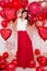 Valentine`s day concept - full length portrait of pretty woman with heart-shaped balloons