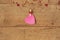 Valentine`s Day concept. Heart shape garland. Pink paper message heart hanging on rope on wooden background