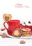 Valentine`s Day concept / red cup of coffee and biscuits shaped