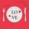 Valentine`s day concept. There are red hearts and the text Love on a plate