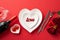 Valentine`s Day concept. Top view photo of heart shaped dishes with inscription love knife fork wine bottle wineglass with