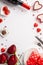 Valentine`s Day concept. Top view vertical photo of wine bottle bouquet of roses giftbox heart shaped saucer candies cutlery