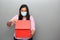 Valentine`s day in contingency covid-19. latin woman with protection mask clinical use and red box of ragalo