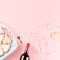 Valentine`s day cookies, wine glasses and wine on pink background.