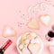 Valentine`s day cookies, wine glasses and wine on pink background.