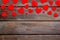 Valentine`s Day design. Red hearts frame on dark wooden background top-down copy space