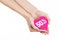 Valentine\'s Day discounts topic: Hand holding a card in the form of a pink heart with a discount of 50% on an isolated