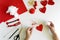 Valentine`s day felt crafts. Woman hands sewing red hearts. DIY. Flat lay. Top view