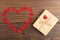 Valentine`s Day greetings concept. Little red wooden crafted hearts and gift boxes on the wooden background. Valentines greeting