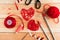 Valentine`s Day Handmade Red Thread Hearts and needlework supplies on wooden background. Valentine`s Day Holiday Background with h
