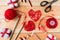 Valentine`s Day Handmade Red Thread Hearts and needlework supplies on wooden background. Valentine`s Day Holiday Background with h