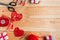 Valentine`s Day Handmade Red Thread Hearts and needlework supplies on wooden background. Valentine`s Day Holiday Background with h