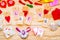 Valentine`s day holiday. cute decorations: paper hearts, clips, origami envelopes on wooden background