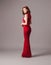 Valentine\'s day look idea. Sexy ginger woman in bright red fitting dress. Womenâ€™s fashion concept.