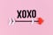 Valentine`s day love arrow and XOXO text on pink background