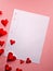 Valentine`s day, love letter template background. Translucent shiny red hearts and an blank paper sheet. Digital render
