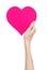 Valentine\'s Day and love theme: hand holding a pink heart isolated on a white background