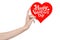 Valentine\'s Day and love theme: hand holds a greeting card in the form of a red heart with the words Happy Valentine\'s day