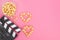 Valentine`s Day movie concept. Movie clapperboard with caramel popcorn hearts with copy space