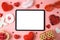 Valentine`s day online dating concept with digital mock up,  gift box and heart shape on pink background