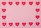 Valentine`s Day pink background with red and pearl hearts. Valentine greeting card. Flat lay style