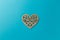 Valentine`s Day postcard. Wooden heart on blue background. Copy space. Top view