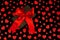 Valentine`s Day. Presented as a red ribbon on a black paper with red hearts