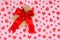 Valentine`s Day. Presented as a red ribbon on a pink paper with red hearts