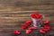 Valentine`s Day. Red hearts in a small metal bucket on an old wooden, blurred background.
