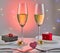 Valentine's Day or romantic birthday dinner with candy hearts, glasses of champagne and elegant table setting with reflection