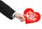 Valentine\'s Day and sale topic: Hand of a man in a black suit holding a card in the form of a red heart with the word Sale