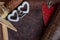 Valentine`s day, strawberry heart and two white heart symbols on leather background