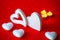 Valentine& x27;s Day - White big hearts on the red background of the ass lit romantic candles . An atmosphere of love and