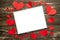 Valentine`s Day. White frame for an inscription with red hearts. Background of rustic snags. Texture, copy space, layout for