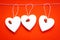 Valentine`s Day. White wooden hearts on a red background and red ladybugs. Blank for the designer. Valentines day concept.