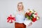 Valentine`s day or women`s day concept - portrait of surprised beautiful and elegant plus size blonde woman holding box with