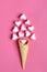 Valentine`s postcard - marshmallows in the shape of a heart and ice cream cone on a pink background