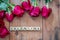 Valentine sign on wooden cubes and red roses flower on wooden table. Love and Valentine day