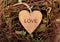 Valentine from a tree with an inscription. Wooden valentines on background of dried twigs. Decoration made from natural materials.