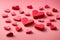 Valentine week Background of a collection of red and pink paper hearts arranged at the bottom of a light pink background.
