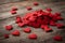 Valentine week Background of a red felt hearts of various sizes scattered on a weathered wooden surface.