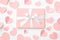 Valentine or women day coral gift box with bow ribbon decorated with pink or coral hearts top view on white background. Flat lay