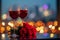 Valentines charm red wine, roses, city lights on a table