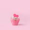 Valentines cupcake with a pink heart shaped cake pick on a pink background, Saint Valentine romance monochrome concept, sweet food