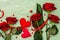 Valentines Day background with assorted hearts, fresh burgundy roses and red festive ribbon