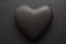 Valentines day background. Close-up of black textured heart, on black