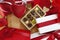 Valentines day background composition of gift boxes chocolates and red heart metal shaped boxes with bows and ribbons top view