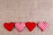 Valentines Day background with fabric hearts on sackcloth, copy