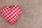 Valentines Day background. Handmade checkered fabric heart on sa
